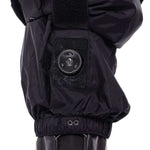 The 686 Women's Geode Thermagraph Bib 2023 is shown from the front in black with an insulated hood and faux fur trim.