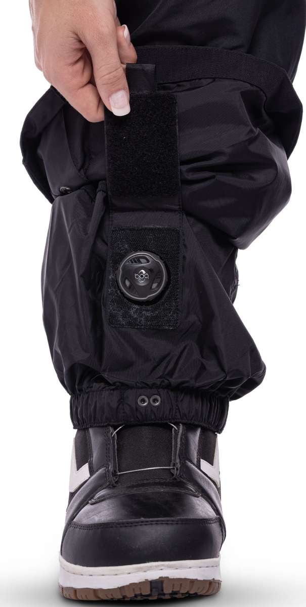 The 686 Women's Geode Thermagraph Bib 2023 is black with a red stripe on the side and has a zippered leg.