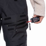 The 686 Women's Geode Thermagraph Bib 2023 is primarily black with an insulated hood and zippered leg pockets.