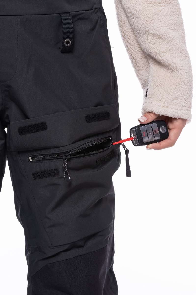 The 686 Women's Geode Thermagraph Bib 2023 is black with a red zipper and an insulated hood.