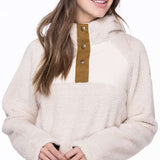 The 686 Ladies Hemlock Fleece Hoodie 2023 is primarily white with brown accents and a large hood.