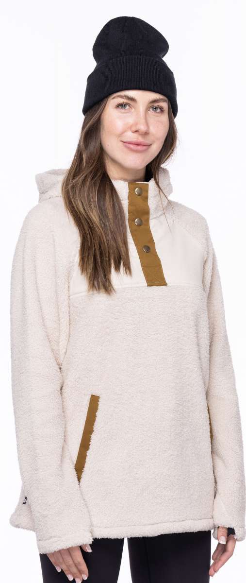 The 686 Ladies Hemlock Fleece Hoodie 2023 features a white fleece material with brown accents and a large hood on a side view.