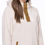 The 686 Ladies Hemlock Fleece Hoodie 2023 features a white fleece material with brown accents and a large hood on a side view.