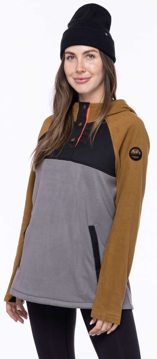 The 686 Ladies Hemlock Fleece Hoodie 2023 is gray with a tan color block design on the front.