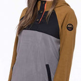 The 686 Ladies Hemlock Fleece Hoodie 2023 is gray with a tan color block design on the front.