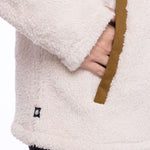 The 686 Ladies Hemlock Fleece Hoodie in cream has an insulated hood and a brown drawstring.