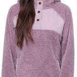 The 686 Women's Hemlock Fleece Hoodie 2024 is primarily mauve with a lighter-colored panel across the chest.