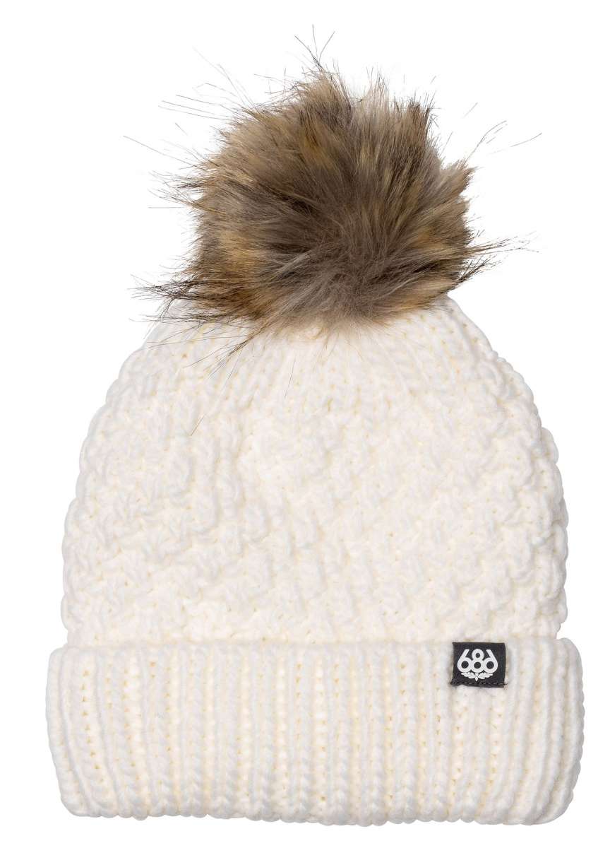 The 686 Majesty Beanie has a white cable knit design with a brown faux fur pom-pom on top.