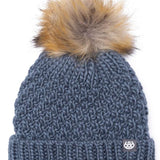 The 686 Majesty beanie is dark gray with a tan faux fur pom-pom on top.