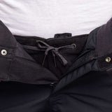 The 686 Women's Smarty 3-in-1 Cargo Pant has a black quilted waistband and cuffs with silver zippers on a black background.