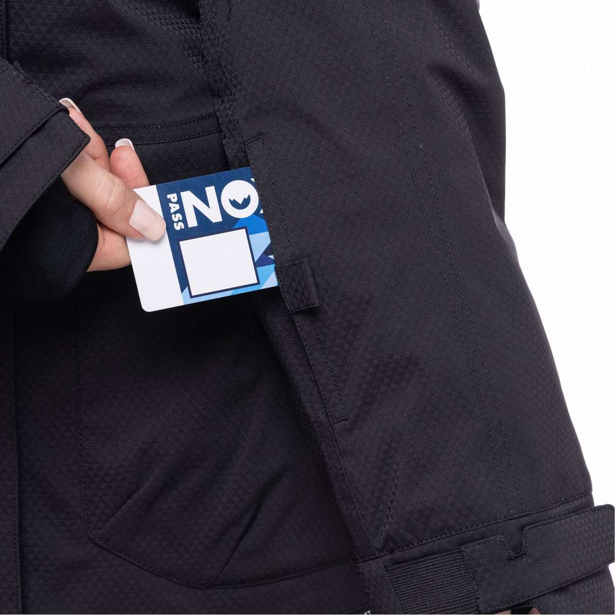 The 686 Women's Spirit Insulated Jacket 2024 is black with a white square on the left breast and a blue tag in the upper right chest area.