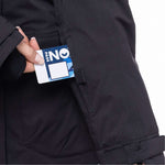 The 686 Women's Spirit Insulated Jacket 2024 is black with a white square on the left breast and a blue tag in the upper right chest area.