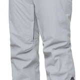 The 686 Women's Standard Shell Pant 2024 is primarily light grey with black accents and has zippered pockets at each side.