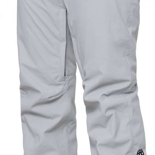 The 686 Women's Standard Shell Pant 2024 is primarily light grey with black accents and has zippered pockets at each side.