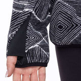 The 686 Tioga fleece pullover has a black and white geometric pattern with a solid black trim around the wrists.