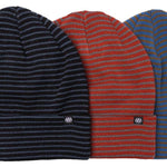 A set of three beanies by 686 in navy blue, red, and blue striped colors.