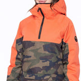 The 686 Ladies' Upton Insulated Jacket 2023 is shown from the front, with an orange top section and a camouflage-patterned bottom section featuring a hood.
