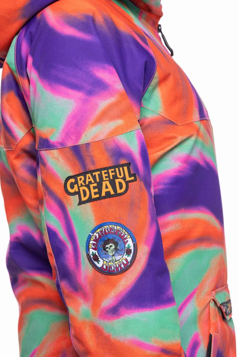 The 686 Ladies' Upton Insulated Jacket 2023 is primarily purple with an orange swirl pattern and has a hood.