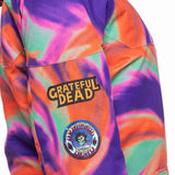 The 686 Ladies' Upton Insulated Jacket 2023 is primarily purple with an orange swirl pattern and has a hood.