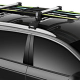 Thule Snowpack M 4 Pairs - This image shows a black plastic roof rack with four pairs of skis mounted on top, each pair secured by two black straps and one yellow strap.