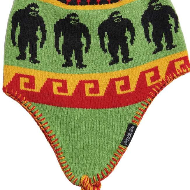 Airblaster Squatchamama Beanie 2023 - A green beanie with a repeating pattern of black Bigfoot silhouettes and red, yellow, and orange accents.