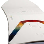 Arbor Women's Poparazzi Camber Snowboard 2023 - A white snowboard with a rainbow-colored stripe along its edge.