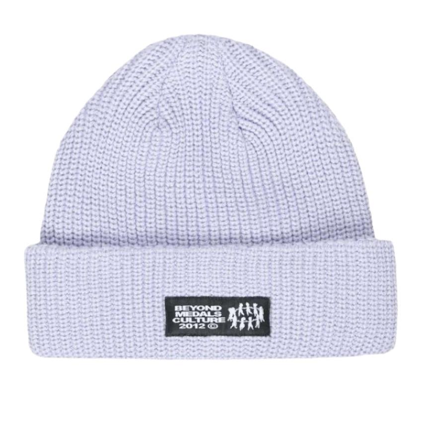 Beyond Medals Culture Beanie 2024 - A light gray beanie with a black patch featuring white text and logo.