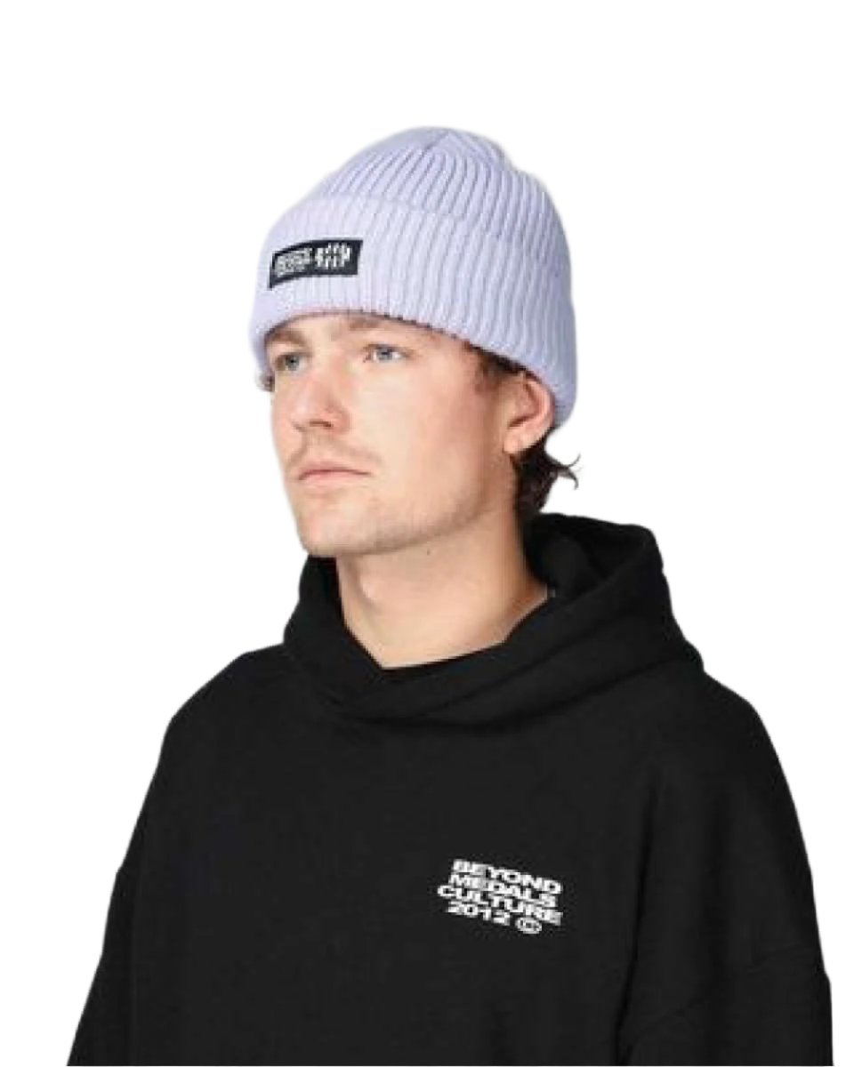 Beyond Medals Culture Beanie 2024 - A light gray beanie with a black rectangular patch on the front featuring white text that reads "BEYOND MEDALS CULTURE".