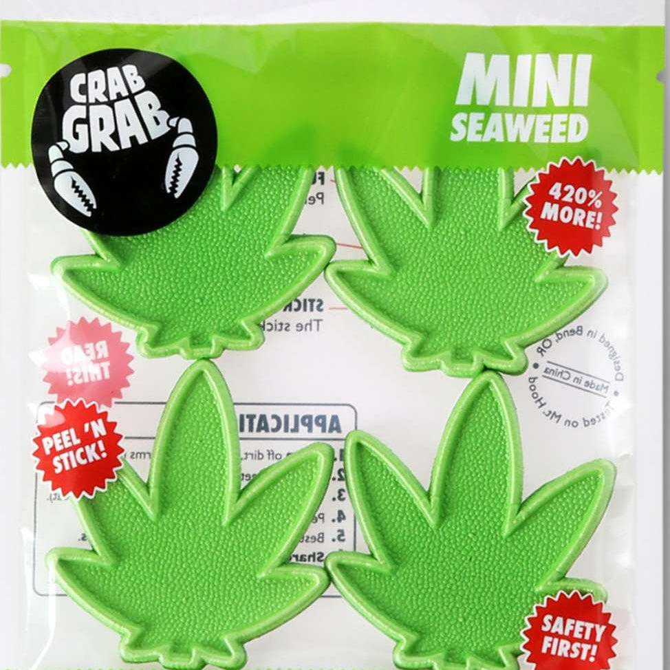 Crab Grab Mini Seaweed Stomp Pad 2023 - Green seaweed-shaped pad with a textured surface and three small suction cups on the bottom.