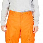 DC Banshee Insulated Pant 2023 - A pair of bright orange snow pants with a black logo on the left thigh and a zippered pocket on the right hip.