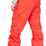 DC Banshee Insulated Pant 2023 - A pair of bright red snow pants with cargo pockets on the side and a black logo patch near the bottom left leg.