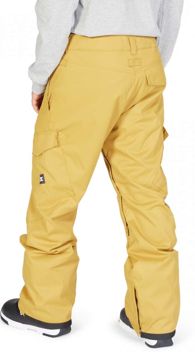 DC Banshee Insulated Pant 2023 - A pair of yellow snow pants with a black logo on the left leg, featuring two cargo pockets and a zippered pocket at the back.