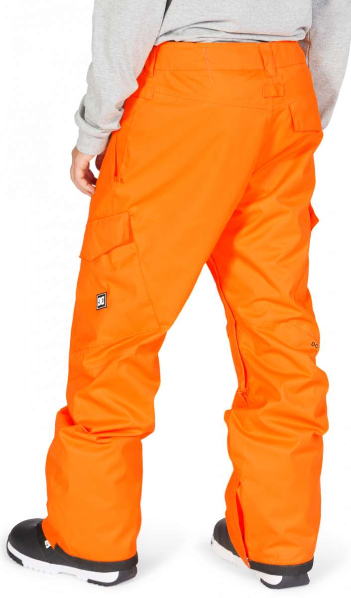 DC Banshee Insulated Pant 2023 - A pair of bright orange snow pants with cargo pockets on the side and a black logo patch on the left leg.