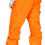 DC Banshee Insulated Pant 2023 - A pair of bright orange snow pants with cargo pockets on the side and a black logo patch on the left leg.