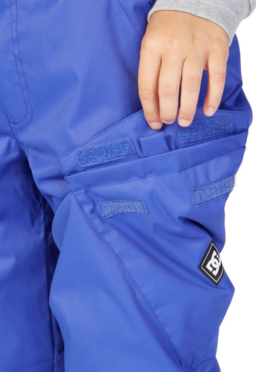 DC Junior's Banshee Insulated Pant 2023 - A pair of blue snow pants with a black logo patch on the left leg.