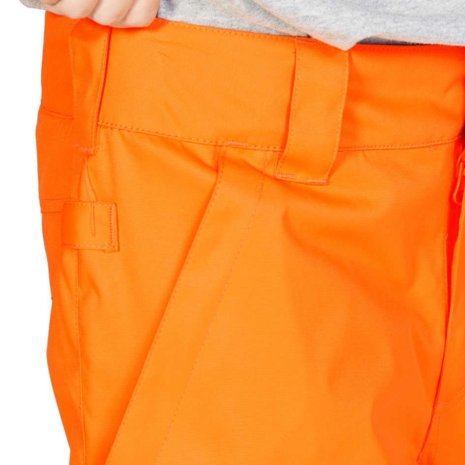 DC Junior's Banshee Insulated Pant 2023 - A pair of bright orange snow pants with a black stripe down the side and a zippered pocket on the thigh.