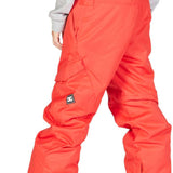 DC Junior's Banshee Insulated Pant - Pant is coral-colored with a black logo patch on the left leg and has a slight sheen to it.
