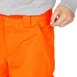 DC Junior's Banshee Insulated Pant 2023 - A pair of bright orange snow pants with a black stripe down the side and a zippered pocket on the thigh.