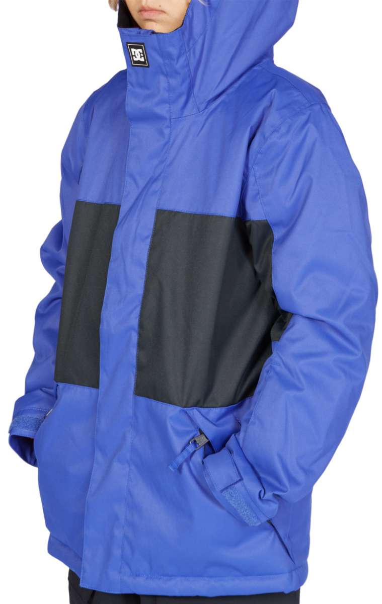 DC Junior's Defy Insulated Jacket 2023 - A royal blue jacket with black rectangular patches on chest and back, featuring a hood and zippered pockets.