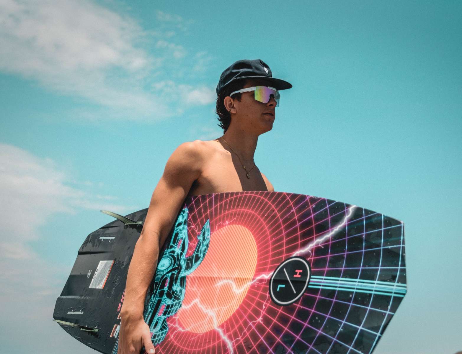 Hyperlite Time Machine Limited Edition Wakesurf Board 2022 - A black wakesurf board with a blue and red graphic of a robot in front of an orange sun.