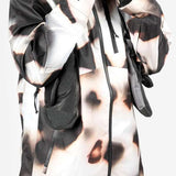Endeavor 3L Shelter Shell Jacket 2024 - A black and white camouflage patterned jacket with a hood, zipper closure, and two zippered pockets on the front.