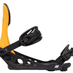 The image shows a pair of K2 Line Up snowboarding bindings for the year 2022. The bindings are black and yellow, with a sturdy design that includes a heel release mechanism. They are positioned on a white background, highlighting their features and colors.