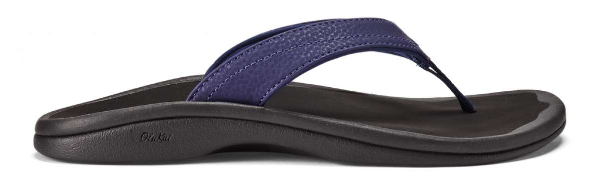 Olukai Women's Ohana Sandals - A pair of navy blue sandals with a strap and toe post, featuring a textured pattern on the straps.