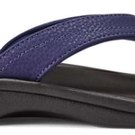 Olukai Women's Ohana Sandals - A pair of navy blue sandals with a strap and toe post, featuring a textured pattern on the straps.