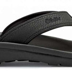 Olukai Ohana Sandals 2022 - A pair of black sandals with a strap and toe post, featuring a logo on the side.