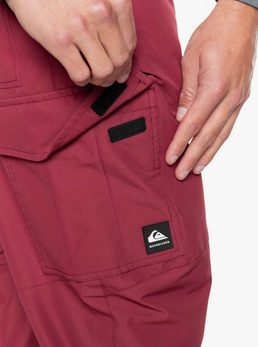 Quiksilver Porter Insulated Pants 2022 - A pair of red insulated pants with a black label featuring the Quicksilver logo and brand name.