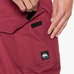 Quiksilver Porter Insulated Pants 2022 - A pair of red insulated pants with a black label featuring the Quicksilver logo and brand name.