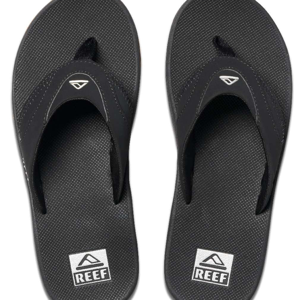 Reef Men's Fanning Sandal - A pair of black sandals with a white logo on top, featuring a strap and toe post.