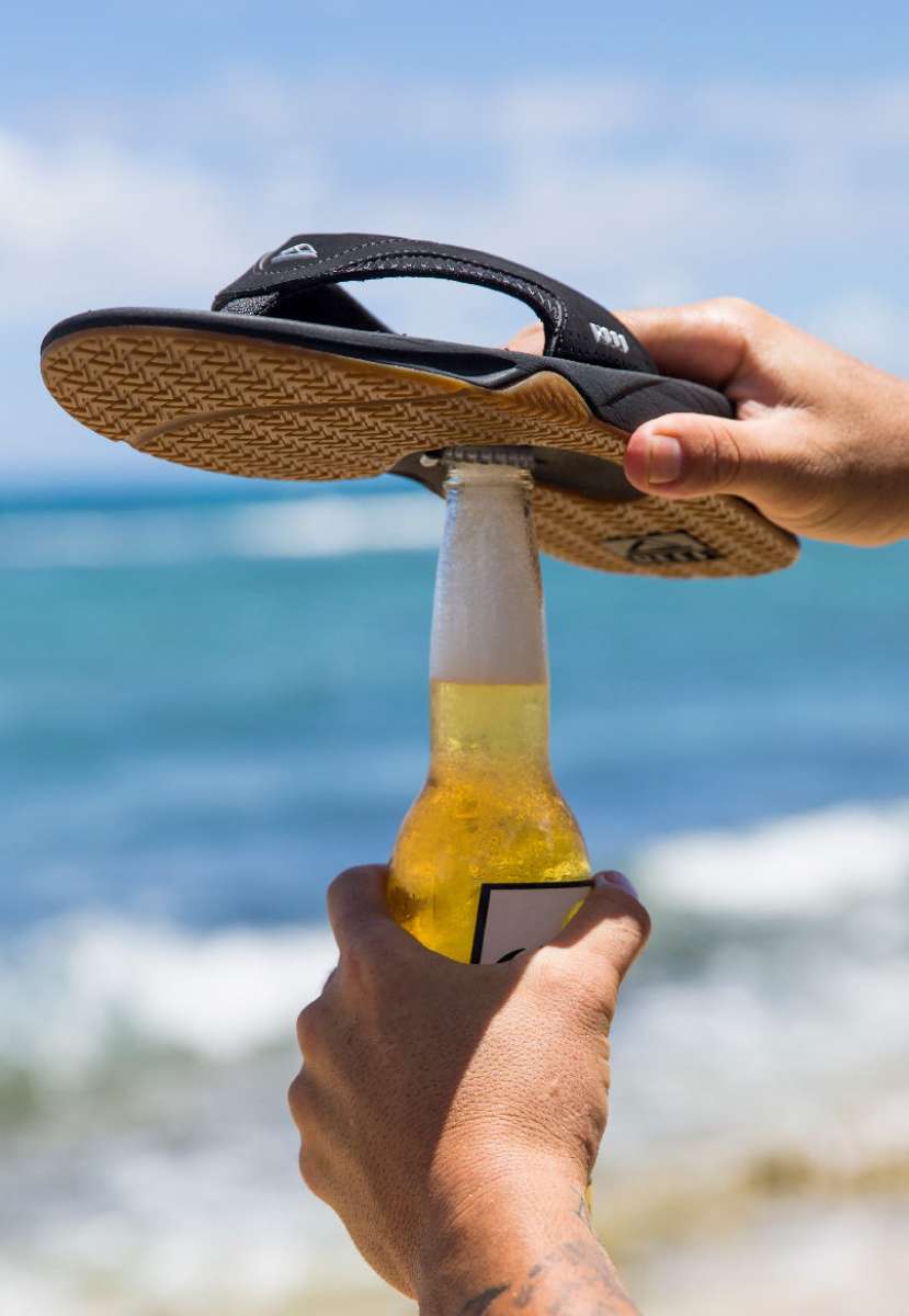 Reef Men's Fanning Sandal - Sandals are black with white accents and a woven strap on top of foot.