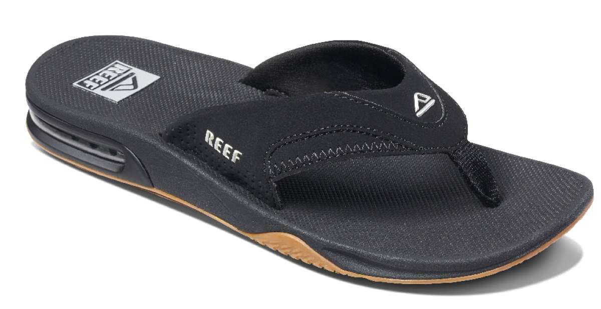 Reef Men's Fanning Sandal - A black sandal with a white logo on top of the footbed, featuring a strap that goes between the big and second toe.
